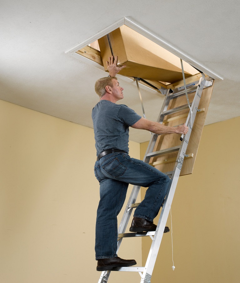 Man-climbing-a-Werner-AH2510-aluminum-attic-ladder
